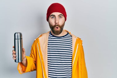 Beyaz, sakallı, termosu olan, ağzı açık, korkmuş ve şaşkına dönmüş bir adam. 