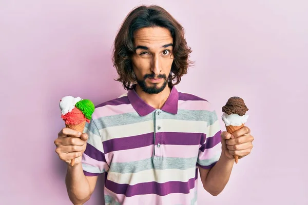 Young Hispanic Man Holding Ice Cream Skeptic Nervous Frowning Upset — Stock Photo, Image
