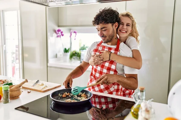 Mladý Pár Usměvavý Šťastný Objímající Vaření Kuchyni — Stock fotografie