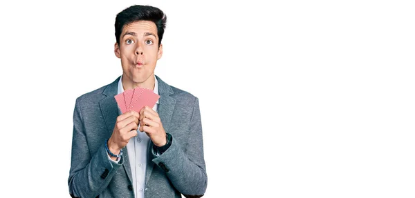 Young Hispanic Business Man Covering Face Cards Making Fish Face — Stock Photo, Image