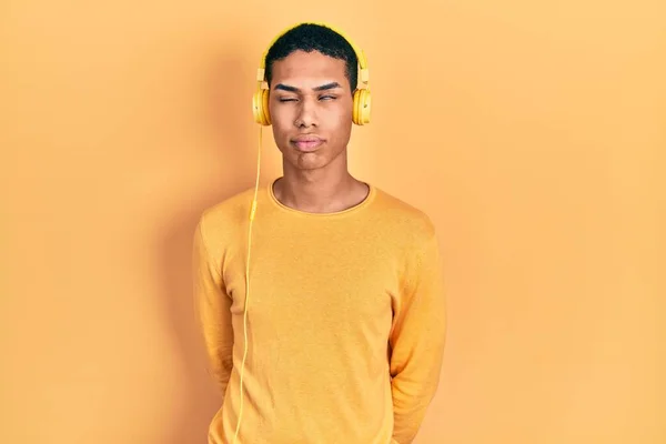 Young African American Guy Listening Music Using Headphones Looking Sleepy — Stock Photo, Image
