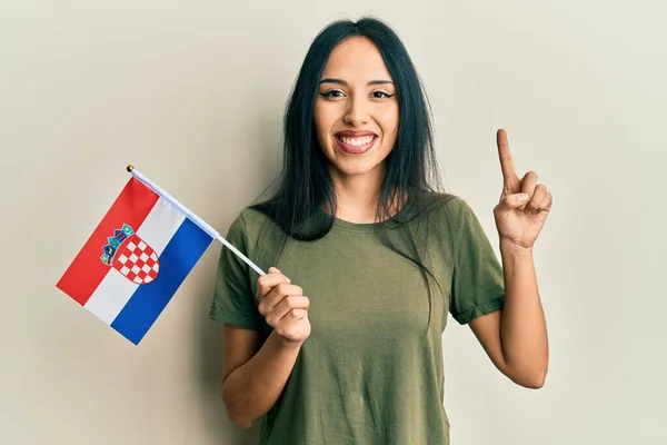 Mladá Hispánka Držící Chorvatskou Vlajku Usmívající Nápadem Nebo Otázkou Ukazující — Stock fotografie
