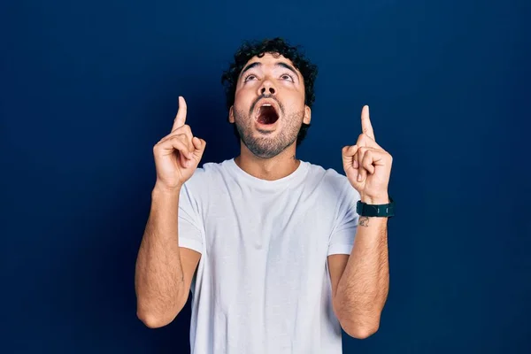 Jovem Hispânico Homem Vestindo Casual Branco Shirt Espantado Surpreso Olhando — Fotografia de Stock