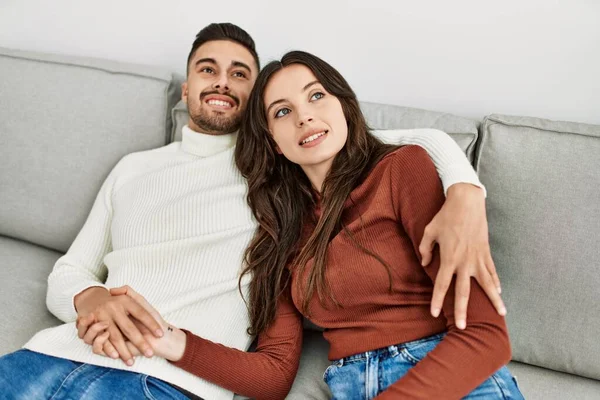 Young Hispanic Couple Hugging Resting Sofa Home — Stock Photo, Image