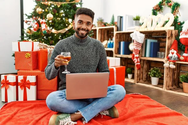 크리스마스에 샴페인을 마시고 집에서 노트북을 사용하는 아프리카 미국인 — 스톡 사진