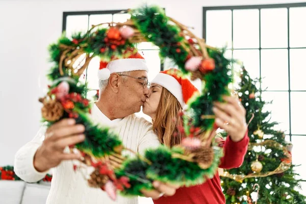 Middle Age Hispanic Couple Kissing Holding Christmas Decor Home — Stock Photo, Image