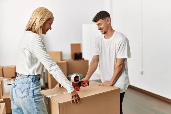 Young Caucasian Couple Smiling Happy Closing Box Using Packing Tape — Stock Photo, Image
