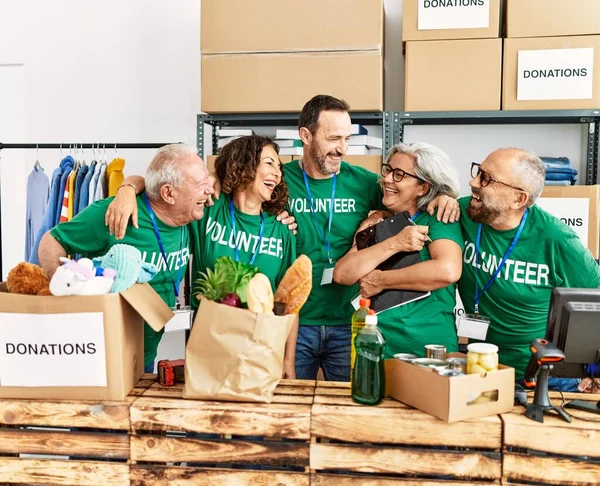 Groep Vrijwilligers Van Middelbare Leeftijd Glimlachend Knuffelend Staand Bij Het — Stockfoto