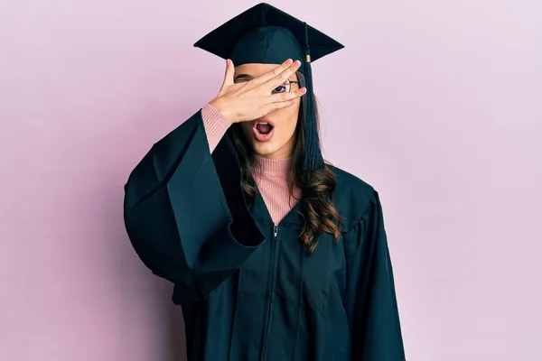 Young Hispanic Woman Wearing Graduation Cap Ceremony Robe Peeking Shock — Stock Photo, Image