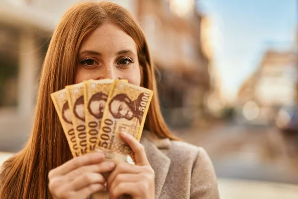 Chica Pelirroja Joven Sonriendo Feliz Cubriendo Cara Con Billetes Forinto — Foto de Stock