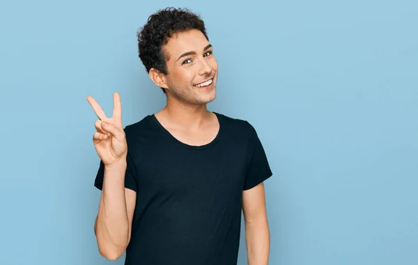 Young Handsome Man Wearing Casual Black Shirt Showing Pointing Fingers — Stock Photo, Image