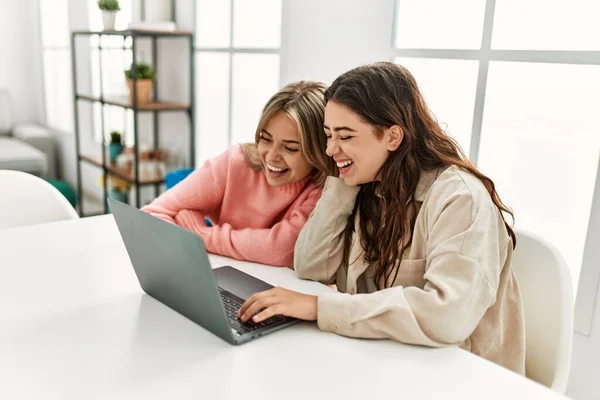 Young couple smiling happy working using laptop at home.