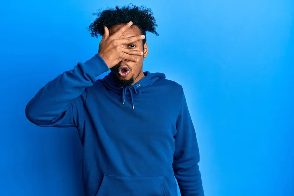 Young African American Man Beard Wearing Casual Sweatshirt Peeking Shock — Stock Photo, Image