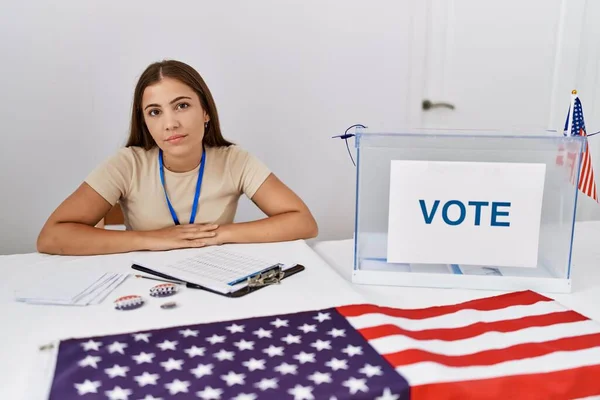 年轻的黑发女子在政治选举中以严肃的表情坐在选票上 简单而自然地看着相机 — 图库照片