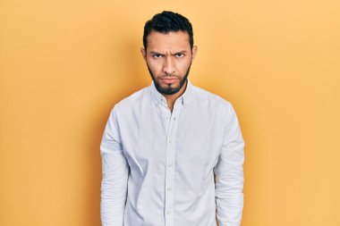 Sakallı, iş gömleği giyen, kuşkucu ve gergin bir İspanyol sorun yüzünden surat asıyor. negatif kişi. 