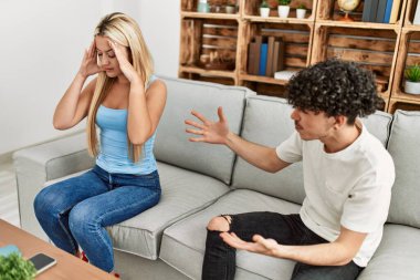 Genç bir çift kanepede oturup tartışıyor..