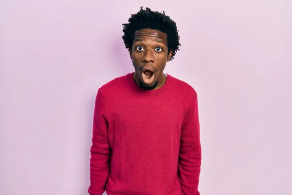 Young african american man wearing casual clothes afraid and shocked with surprise and amazed expression, fear and excited face.