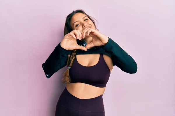 Young Hispanic Girl Wearing Sportswear Headphones Smiling Love Doing Heart — Stock Photo, Image