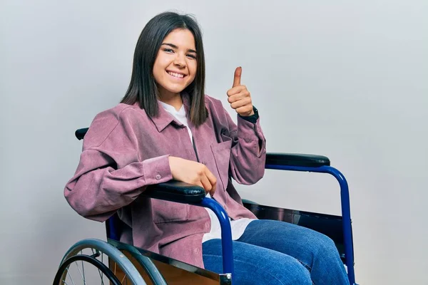 Young Brunette Woman Sitting Wheelchair Doing Happy Thumbs Gesture Hand — Stock Photo, Image