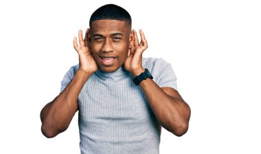 Gündelik tişört giyen genç siyahi adam iki elini de kulak hareketlerinde duymaya çalışıyor, dedikoduya meraklı. İşitme sorunu, sağır 