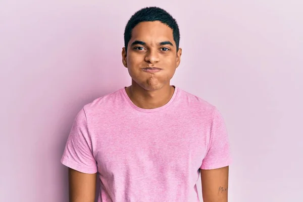 Young Handsome Hispanic Man Wearing Casual Pink Shirt Puffing Cheeks — Stock Photo, Image