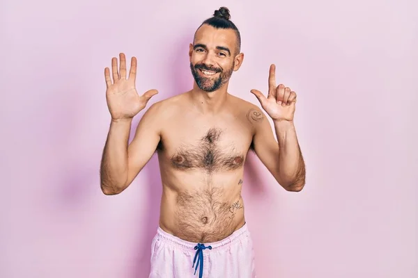 Young Hispanic Man Shirtless Wearing Swimsuit Showing Pointing Fingers Number — Stock Photo, Image