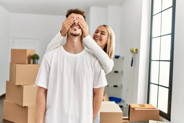 Woman Surprising Her Boyfriend Covering Eyes Hands New Home — Stock Photo, Image