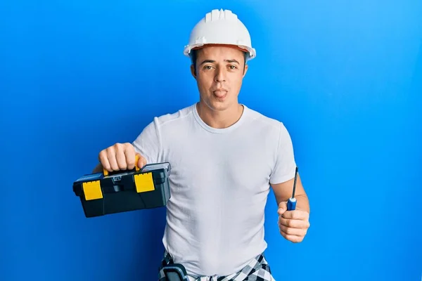 Bonito Jovem Segurando Caixa Ferramentas Chave Fenda Furando Língua Feliz — Fotografia de Stock