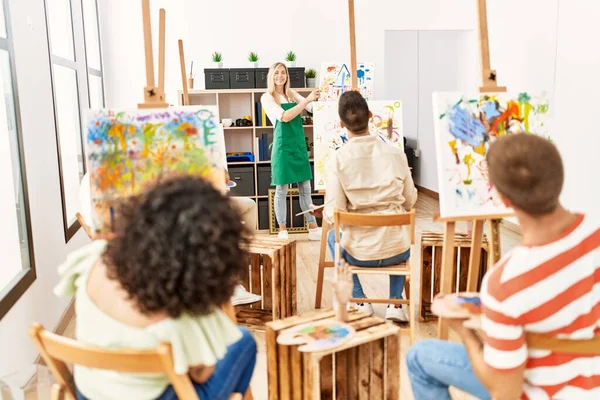 Group of people having paint class at art studio.