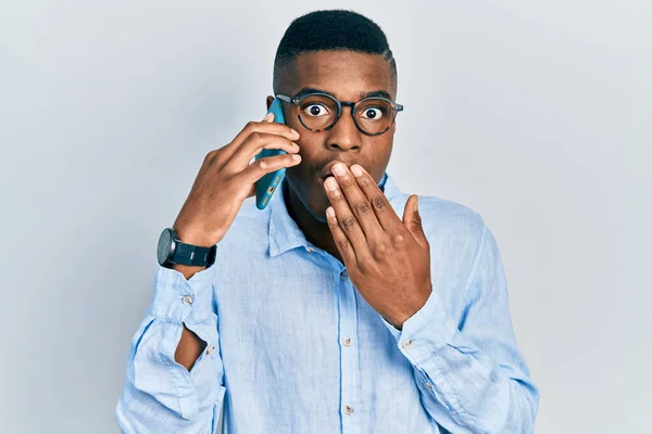 Young African American Man Having Conversation Talking Smartphone Covering Mouth — Stock Photo, Image