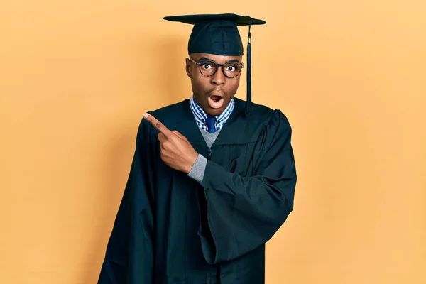 Young African American Man Wearing Graduation Cap Ceremony Robe Surprised — Stock Photo, Image