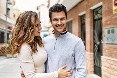 Genç İspanyol çift şehirde birbirlerine sarılıyorlar. Kız arkadaş ve erkek arkadaş aşkla sokakta yürüyorlar.