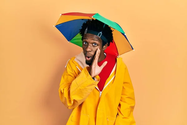 Young African American Man Wearing Yellow Raincoat Hand Mouth Telling — Stock Photo, Image