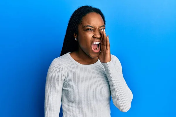 African American Woman Braided Hair Wearing Casual White Sweater Shouting — Stock Photo, Image