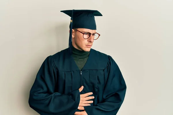 Young Caucasian Man Wearing Graduation Cap Ceremony Robe Hand Stomach — Stock Photo, Image