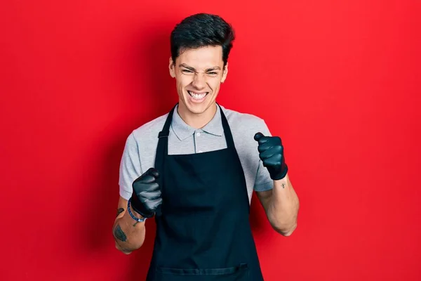 Young Hispanic Man Wearing Apron Excited Success Arms Raised Eyes — Stock Photo, Image