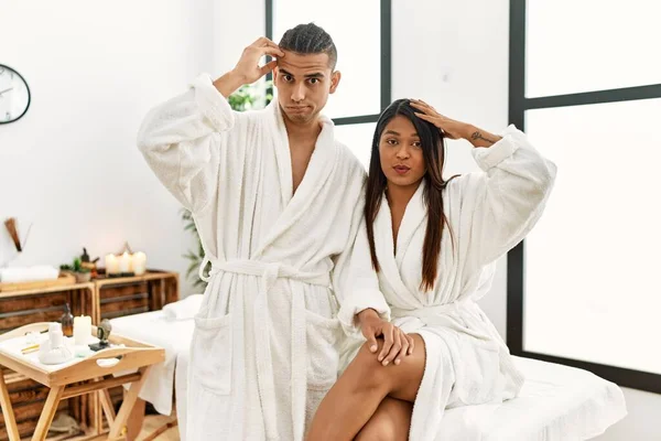 Young Latin Couple Wearing Towel Standing Beauty Center Worried Stressed — Stockfoto