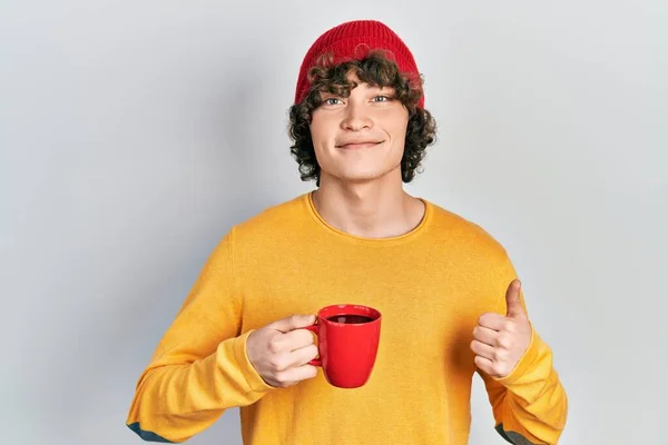 Przystojny Młody Człowiek Pijący Kawę Uśmiecha Się Szczęśliwy Pozytywny Kciuk — Zdjęcie stockowe