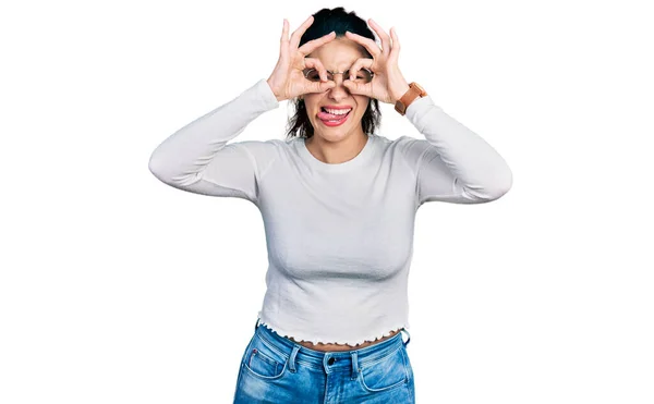 Young Hispanic Woman Wearing Casual Clothes Doing Gesture Binoculars Sticking — Stock Photo, Image