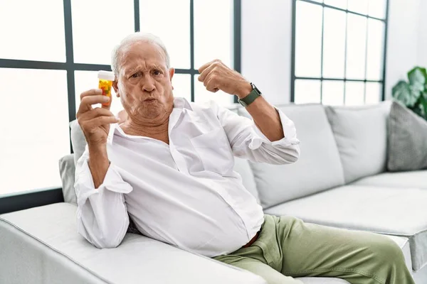 Senior Man Holding Pills Strong Person Showing Arm Muscle Confident — Stock Photo, Image