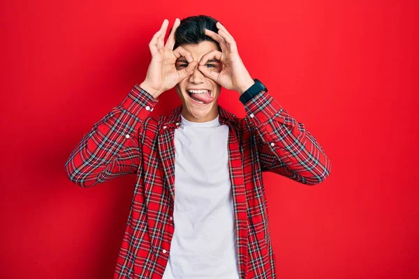 Young Hispanic Man Wearing Casual Clothes Doing Gesture Binoculars Sticking — Stock Photo, Image