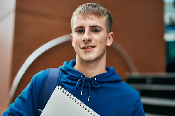 Joven Estudiante Rubia Sonriendo Feliz Sosteniendo Cuaderno Universidad —  Fotos de Stock