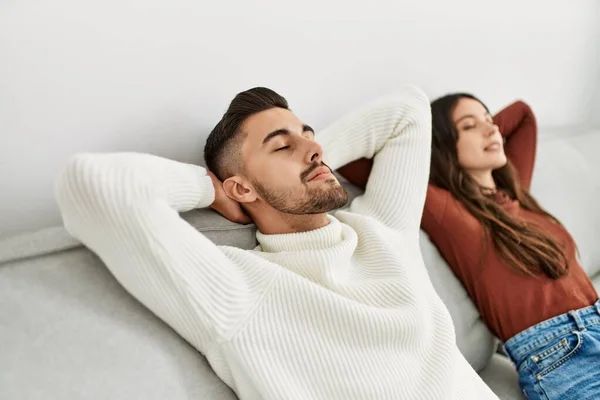 Young Hispanic Couple Resting Head Hands Sitting Sofa Home — Stock Photo, Image