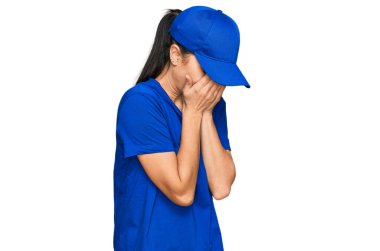 Postacı üniforması giyen genç İspanyol kız. Ağlarken suratını ellerle kapatan üzgün bir ifade. depresyon kavramı. 