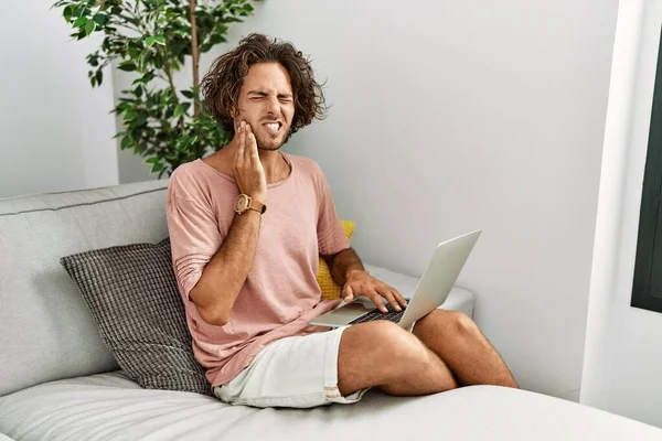 Young Hispanic Man Sitting Sofa Home Using Laptop Touching Mouth — Stock Photo, Image