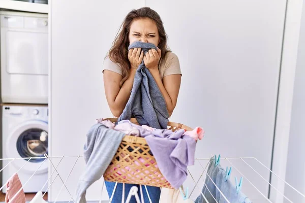 Young Hispanic Girl Doing Laundry Smelling Clothes Home — Stock Photo, Image