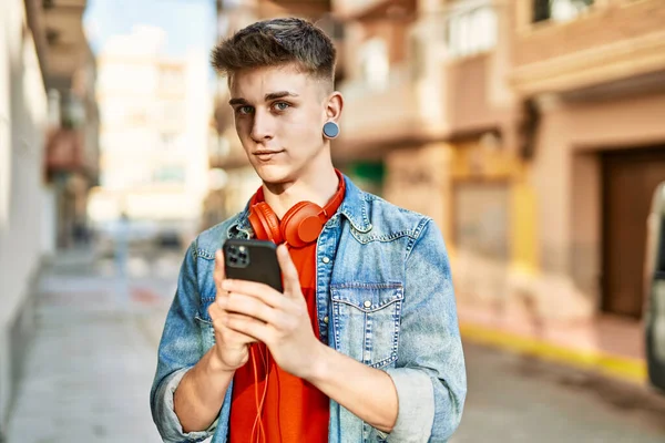 Νεαρός Καυκάσιος Τύπος Χαμογελά Χρησιμοποιώντας Smartphone Στην Πόλη — Φωτογραφία Αρχείου