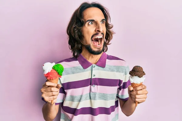Young Hispanic Man Holding Ice Cream Angry Mad Screaming Frustrated — Stock Photo, Image