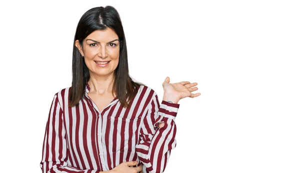 Beautiful Brunette Woman Wearing Striped Shirt Smiling Cheerful Presenting Pointing — Stock Photo, Image