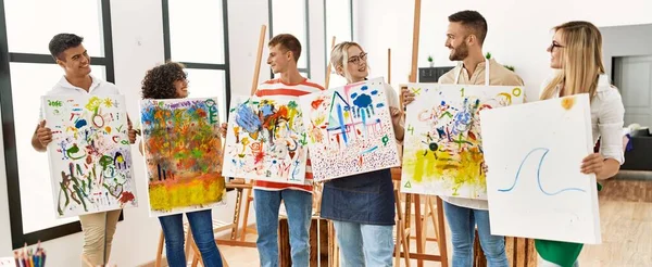 Group of people smiling happy canvas with draw standing at art studio.
